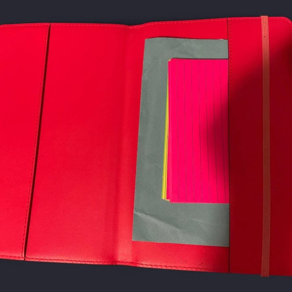 MK pink/red leather organizer/planner cover with repeating MK monogram pattern